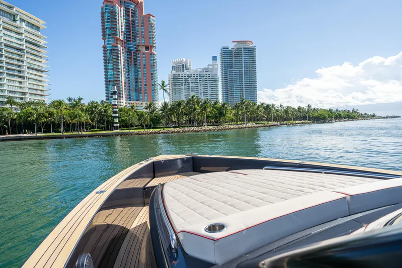 Morgan 1 Yacht Photos Pics 2023 Pardo Yachts 43 cruising near modern waterfront buildings and palm trees.