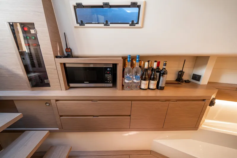 Morgan 1 Yacht Photos Pics Modern kitchen area in 2023 Pardo Yachts 43 with microwave and wine bottles.