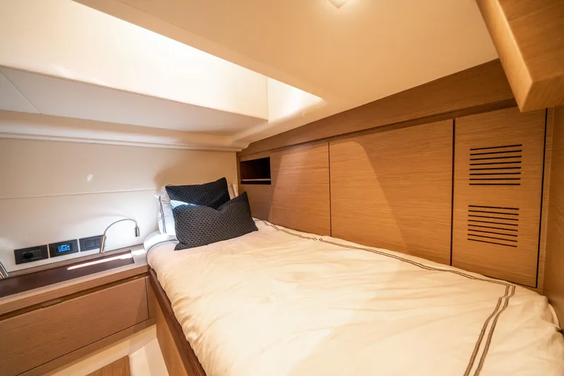 Morgan 1 Yacht Photos Pics Luxurious cabin interior of 2023 Pardo Yachts 43, featuring modern wood finishes and cozy bedding.