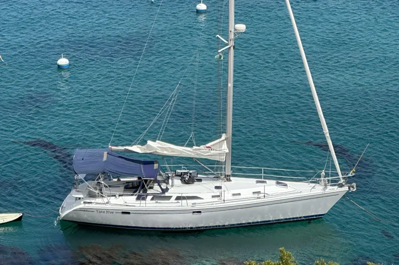Take Five Yacht Photos Pics Sailboat Catalina 42 MkII 1999 anchored in clear blue water.