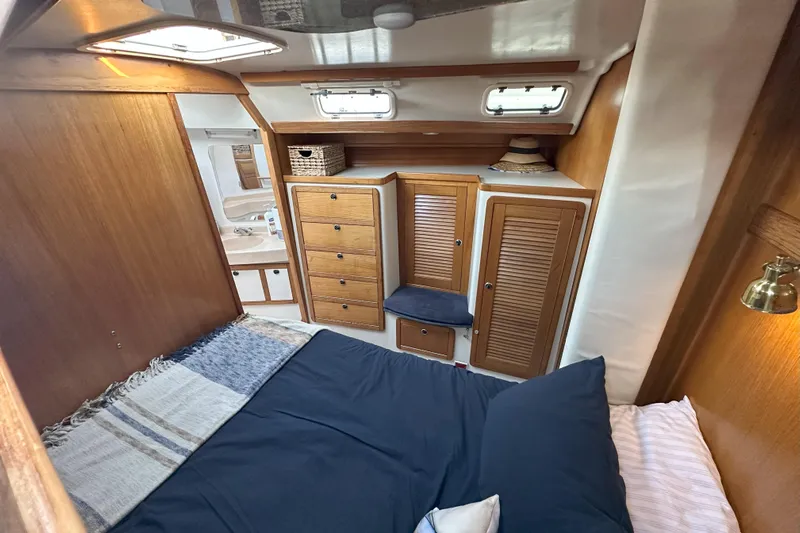 Take Five Yacht Photos Pics Cozy cabin interior of 1999 Catalina 42 MkII sailboat with wood paneling and storage.