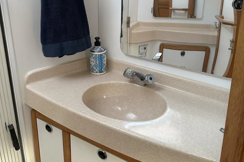 Take Five Yacht Photos Pics Bathroom sink area in a 1999 Catalina 42 MkII yacht, featuring a countertop and mirror.