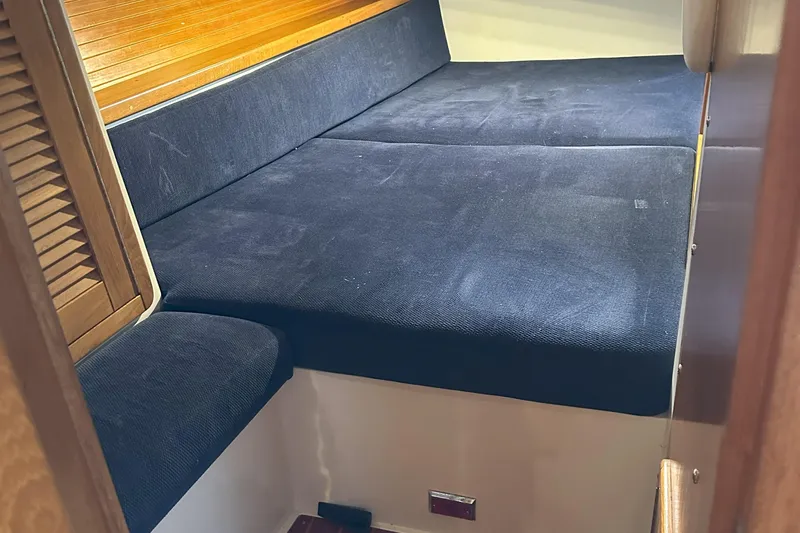 Take Five Yacht Photos Pics Interior cabin of 1999 Catalina 42 MkII sailboat with blue cushions and wooden accents.