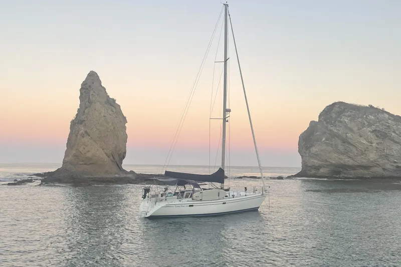 Take Five Yacht Photos Pics Sailboat Catalina 42 MkII (1999) anchored near rocky formations at sunset.
