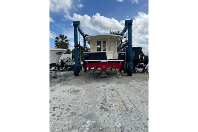Perseus Yacht Photos Pics 2008 Mainship 34 Trawler Hardtop on dry dock under blue sky.