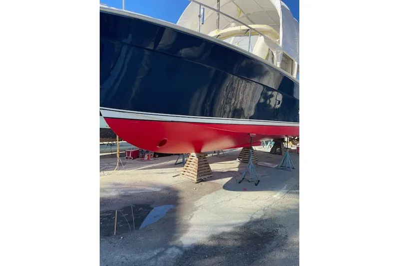 Perseus Yacht Photos Pics 2008 Mainship 34 Trawler Hardtop with blue hull and red bottom on stands.