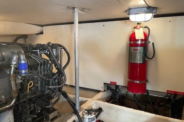 Perseus Yacht Photos Pics Engine room of 2008 Mainship 34 Trawler Hardtop with fire extinguisher and machinery.
