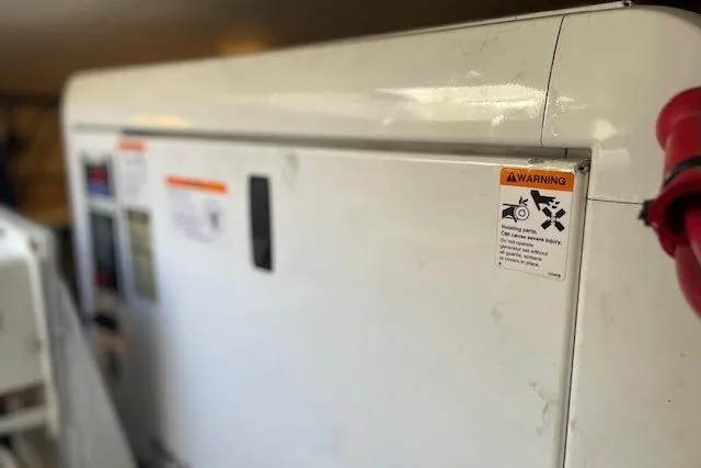 Perseus Yacht Photos Pics 2008 Mainship 34 Trawler Hardtop engine compartment with warning label visible.