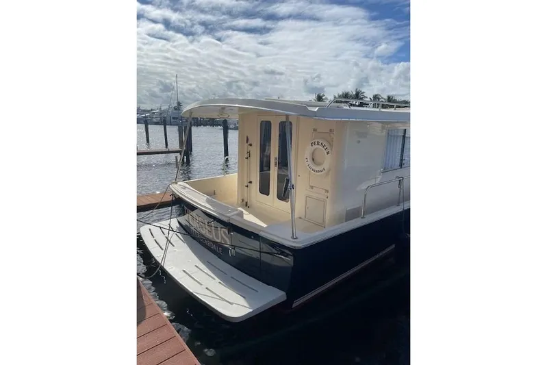 Perseus Yacht Photos Pics 2008 Mainship 34 Trawler Hardtop docked, featuring a spacious rear deck and elegant design.
