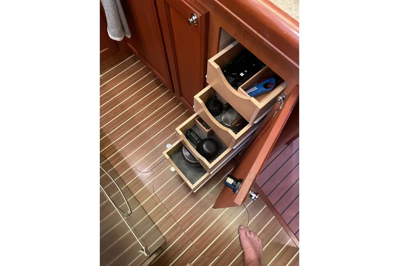 Perseus Yacht Photos Pics Open cabinet drawers in 2008 Mainship 34 Trawler Hardtop, showcasing organized storage.
