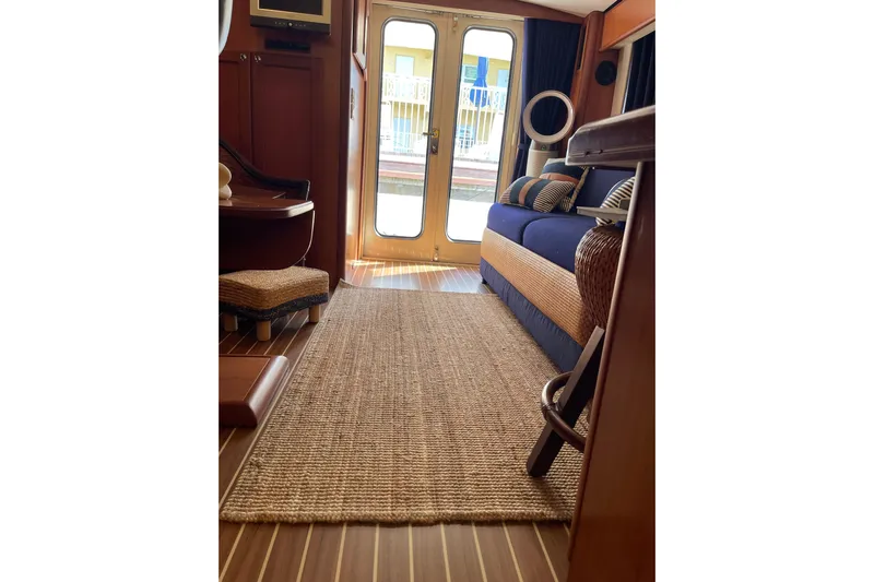 Perseus Yacht Photos Pics Interior of 2008 Mainship 34 Trawler Hardtop with cozy seating and nautical decor.