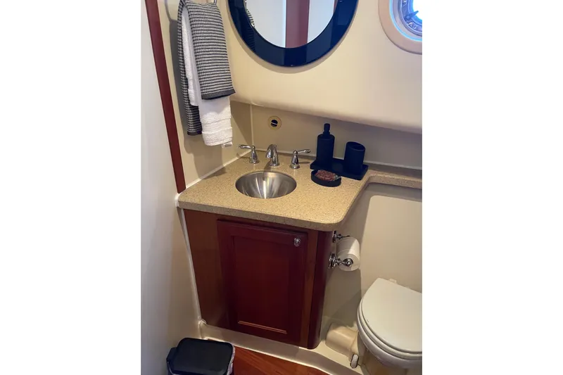 Perseus Yacht Photos Pics 2008 Mainship 34 Trawler Hardtop bathroom with sink, mirror, and toilet.