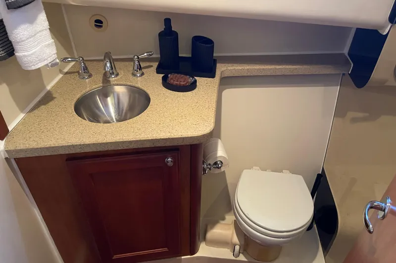 Perseus Yacht Photos Pics 2008 Mainship 34 Trawler Hardtop bathroom with sink, countertop, and toilet.