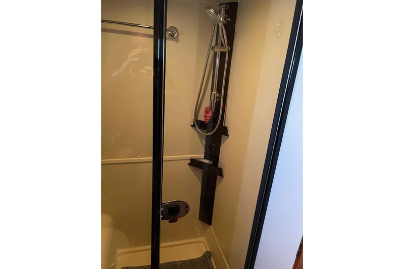 Perseus Yacht Photos Pics Shower area in 2008 Mainship 34 Trawler Hardtop, featuring modern fixtures and glass door.