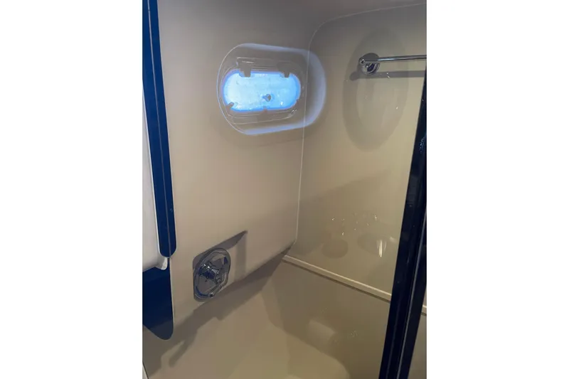 Perseus Yacht Photos Pics Bathroom interior of 2008 Mainship 34 Trawler Hardtop with porthole and shower.