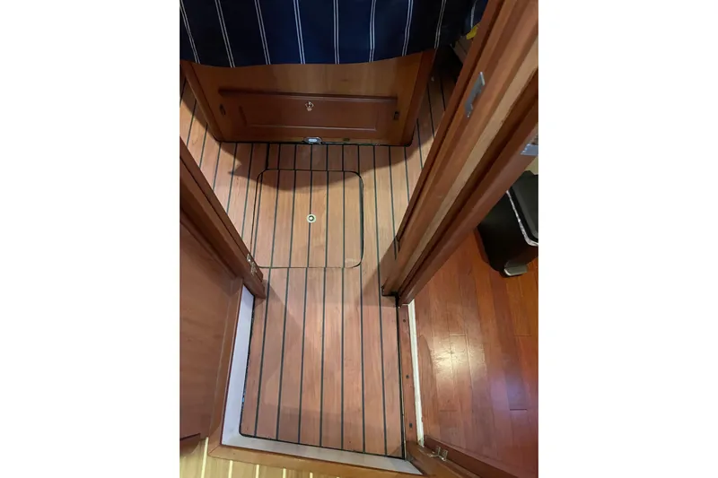 Perseus Yacht Photos Pics Interior view of 2008 Mainship 34 Trawler Hardtop with wood flooring and cabinetry.