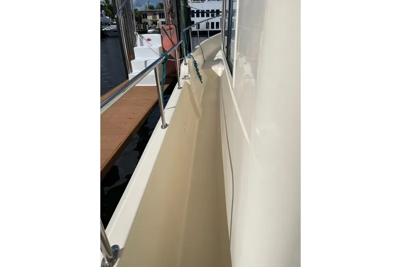 Perseus Yacht Photos Pics 2008 Mainship 34 Trawler Hardtop side deck view at dock.