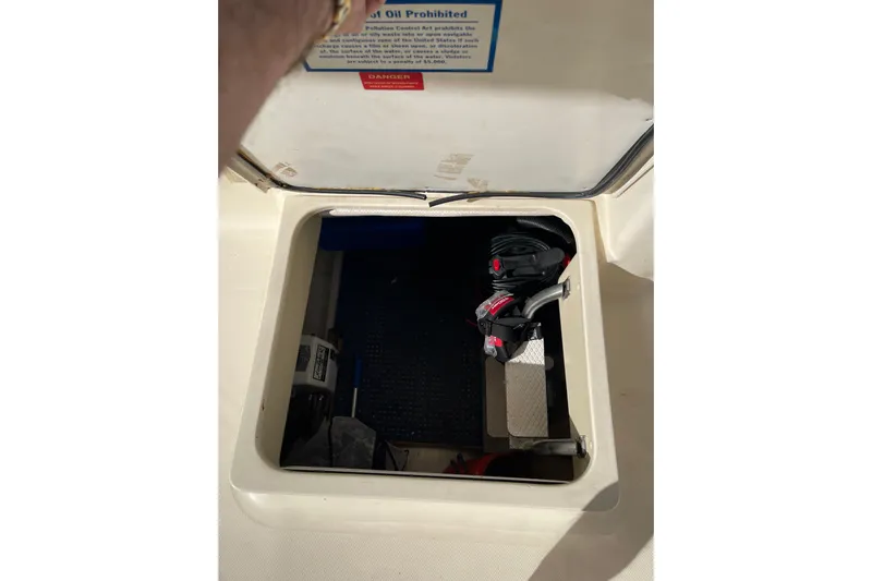 Perseus Yacht Photos Pics Open hatch on 2008 Mainship 34 Trawler Hardtop, revealing interior storage compartment.