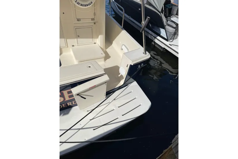 Perseus Yacht Photos Pics 2008 Mainship 34 Trawler Hardtop stern view with swim platform and railing.