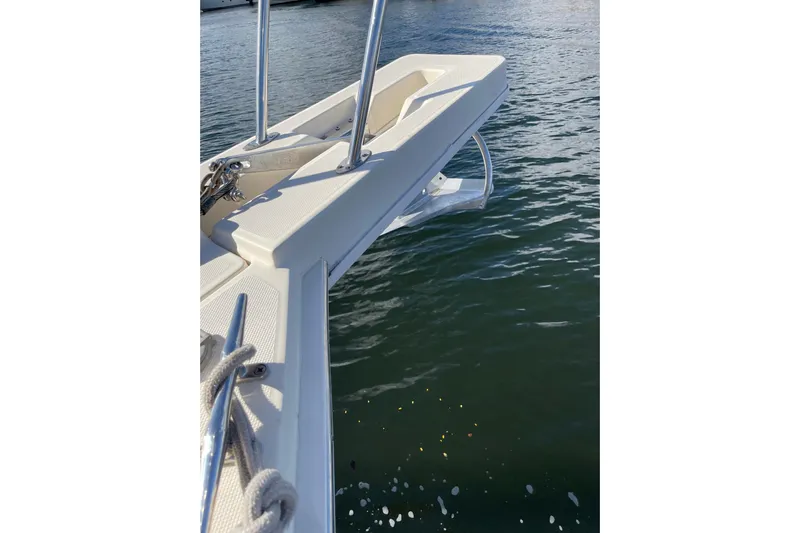 Perseus Yacht Photos Pics 2008 Mainship 34 Trawler Hardtop bow with anchor over water.