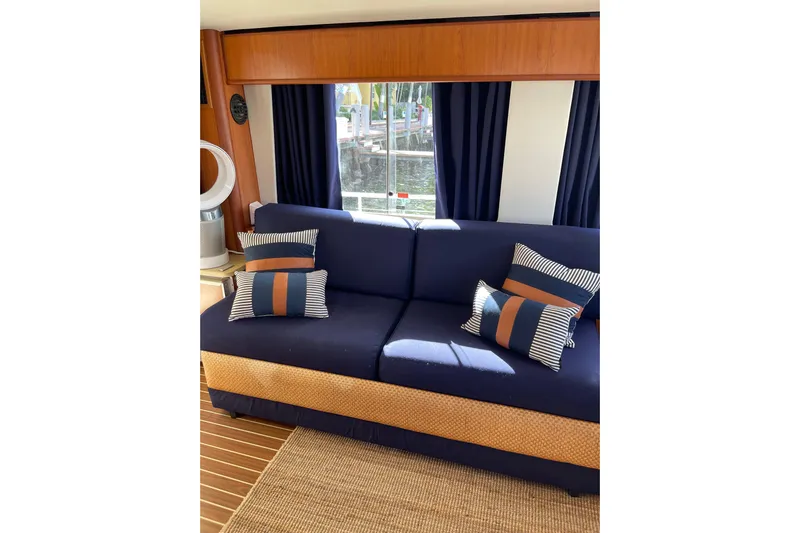 Perseus Yacht Photos Pics Interior of 2008 Mainship 34 Trawler Hardtop with navy sofa and striped cushions.