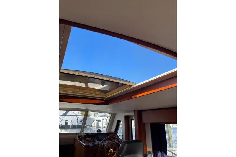 Perseus Yacht Photos Pics Interior view of 2008 Mainship 34 Trawler Hardtop with open sunroof and steering wheel.