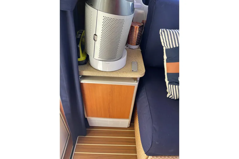 Perseus Yacht Photos Pics Interior of 2008 Mainship 34 Trawler Hardtop with air purifier and striped cushion.