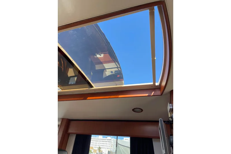 Perseus Yacht Photos Pics 2008 Mainship 34 Trawler Hardtop interior with skylight and clear blue sky view.