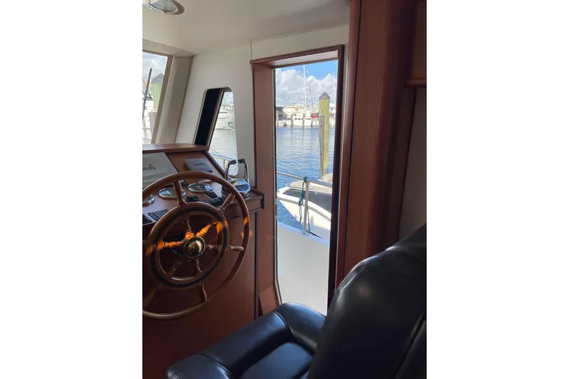 Perseus Yacht Photos Pics 2008 Mainship 34 Trawler Hardtop helm with view of marina through window.