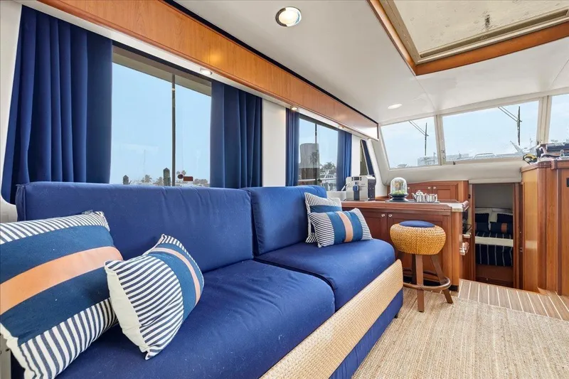 Perseus Yacht Photos Pics Interior of 2008 Mainship 34 Trawler Hardtop with blue sofa and nautical decor.