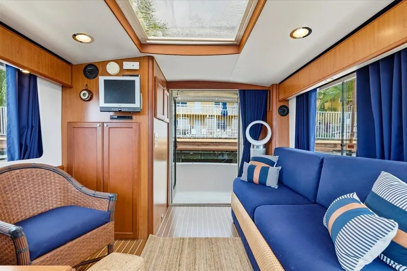 Perseus Yacht Photos Pics Interior of 2008 Mainship 34 Trawler Hardtop with blue seating and wooden accents.