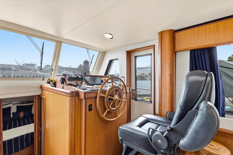 Perseus Yacht Photos Pics 2008 Mainship 34 Trawler Hardtop interior with helm, steering wheel, and captain's chair.