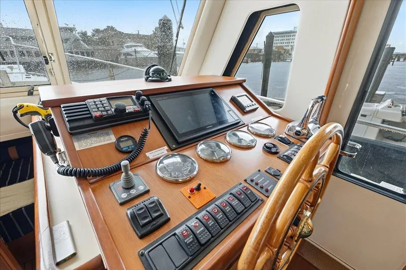 Perseus Yacht Photos Pics 2008 Mainship 34 Trawler Hardtop helm with navigation instruments and wooden steering wheel.