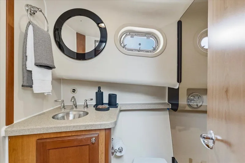 Perseus Yacht Photos Pics Bathroom interior of 2008 Mainship 34 Trawler Hardtop with sink and porthole window.