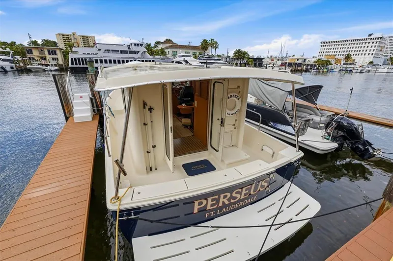 Perseus Yacht Photos Pics 2008 Mainship 34 Trawler Hardtop docked in Fort Lauderdale marina.