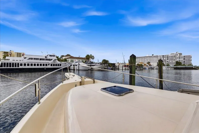 Perseus Yacht Photos Pics 2008 Mainship 34 Trawler Hardtop docked in a marina with blue sky.