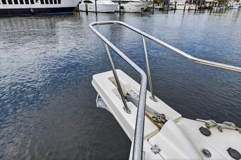 Perseus Yacht Photos Pics Bow of 2008 Mainship 34 Trawler Hardtop at marina, with water and boats in background.
