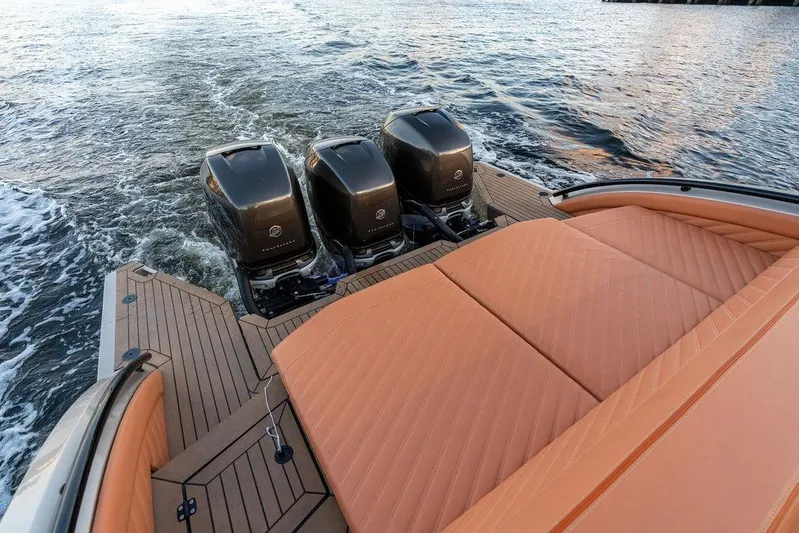  Yacht Photos Pics 2023 DeKoning 43 boat with triple outboard engines and luxurious tan seating on water.