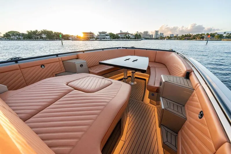  Yacht Photos Pics Luxurious DeKoning 43 yacht interior with elegant seating and table, 2023 model, sunset view.