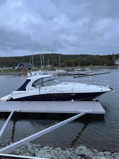 Northern Comfort Yacht Photos Pics 2007 Sea Ray 40 Sundancer yacht docked at a marina under cloudy skies.