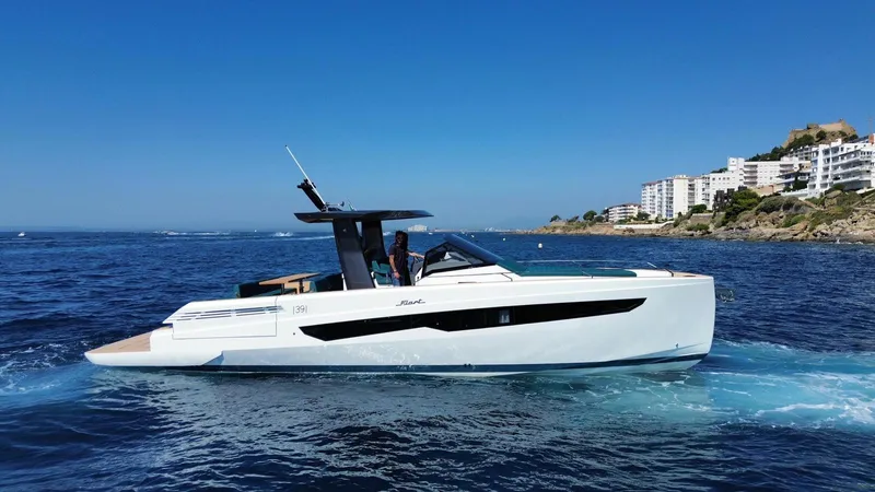 Fiart 39 Sw Yacht Photos Pics 2024 Fiart 39 Seawalker yacht cruising near coastal buildings on a sunny day.