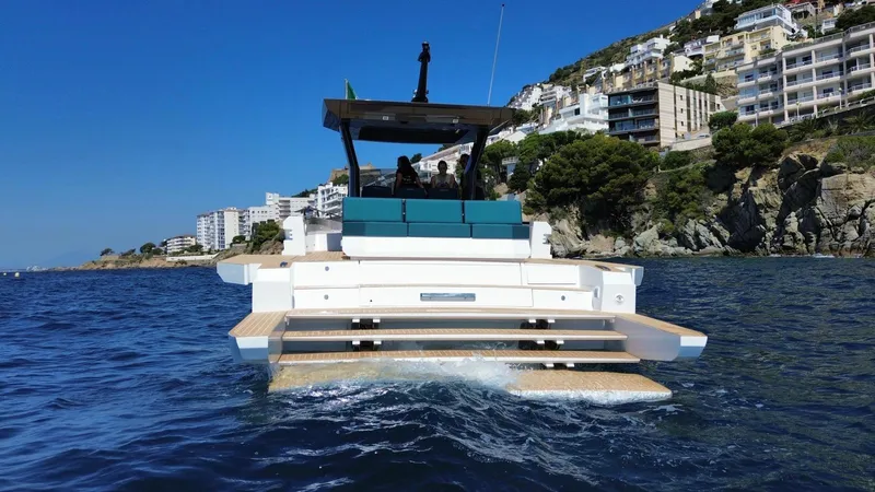 Fiart 39 Sw Yacht Photos Pics 2024 Fiart 39 Seawalker yacht cruising near coastal cliffs and buildings.