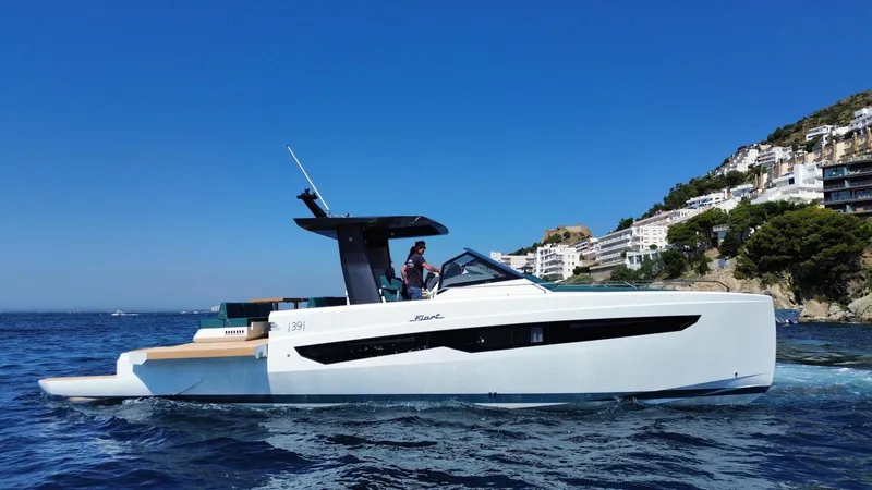 Fiart 39 Sw Yacht Photos Pics 2024 Fiart 39 Seawalker yacht cruising near coastal cliffs under clear blue sky.