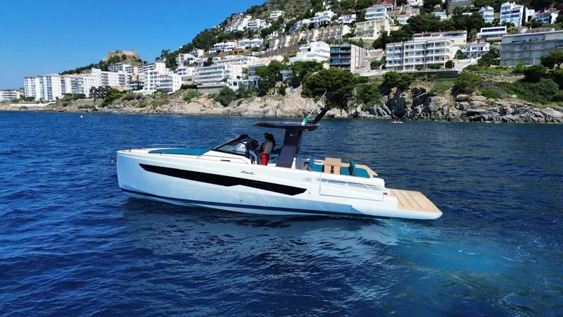 Fiart 39 Sw Yacht Photos Pics 2024 Fiart 39 Seawalker yacht cruising near scenic coastal cliffs and buildings.