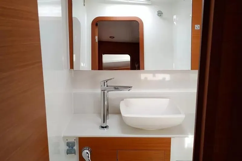  Yacht Photos Pics Modern bathroom interior of 2019 Dufour Exclusive 56 yacht with sleek sink and mirror.