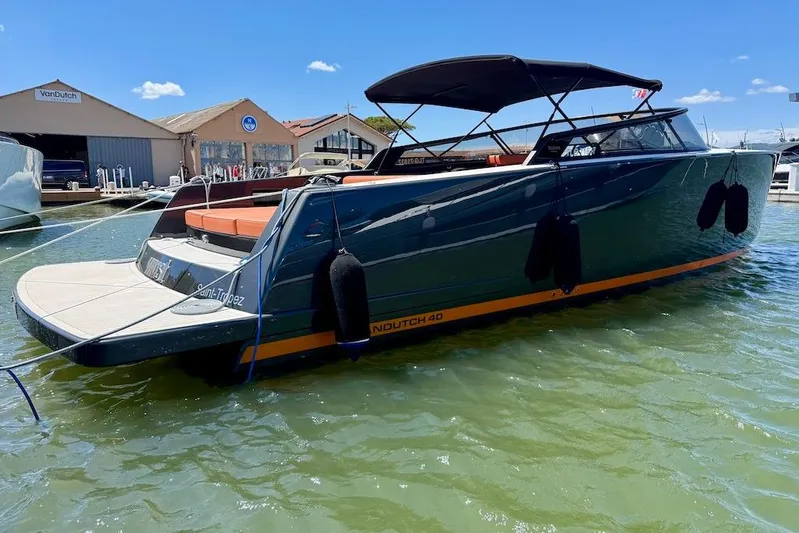 Must Yacht Photos Pics 2024 VanDutch 40 yacht docked in marina, sleek design with canopy, calm water.