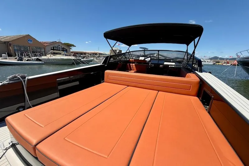 Must Yacht Photos Pics 2024 VanDutch 40 yacht with orange seating, docked at a marina under a clear blue sky.