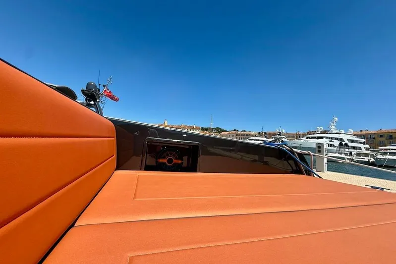 Must Yacht Photos Pics 2024 VanDutch 40 yacht with orange seating, docked in a marina under clear blue skies.