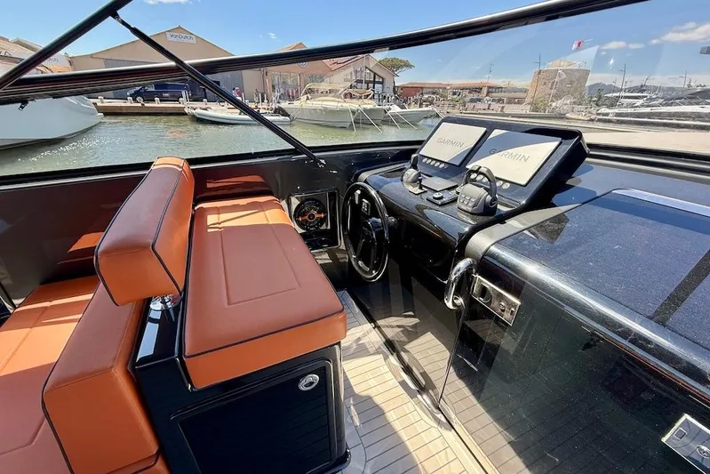 Must Yacht Photos Pics 2024 VanDutch 40 yacht cockpit with orange seating and advanced Garmin navigation systems.