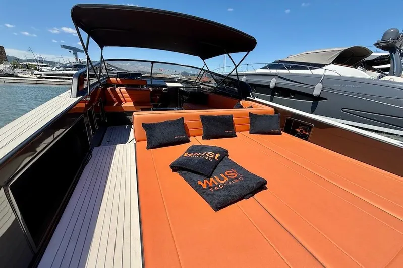 Must Yacht Photos Pics 2024 VanDutch 40 yacht with orange seating, docked at a marina under clear skies.